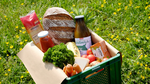 Ökokiste mit Gemüse, Brot, Milch und Naturwaren